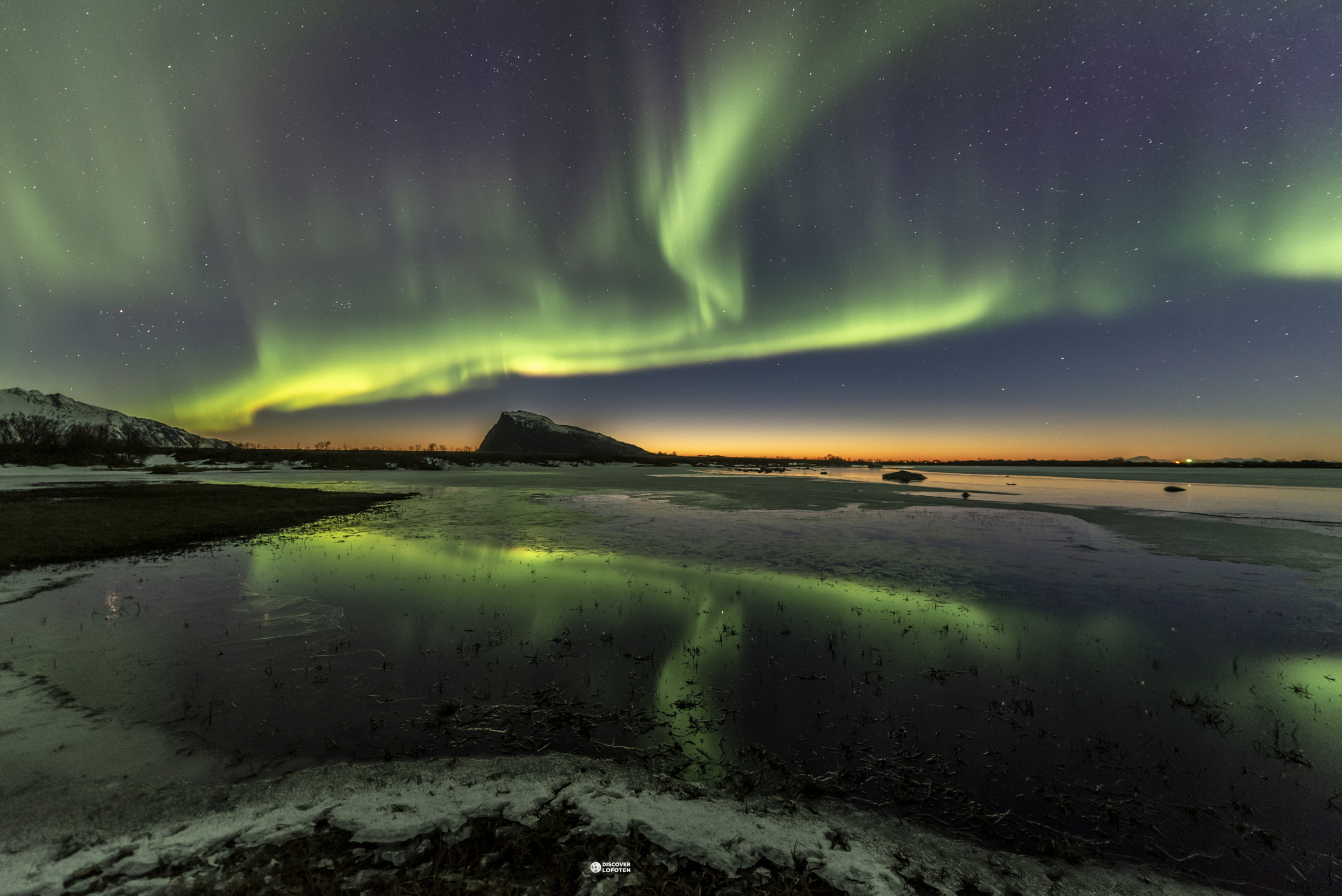 Aurora borealis over Arctic landscape