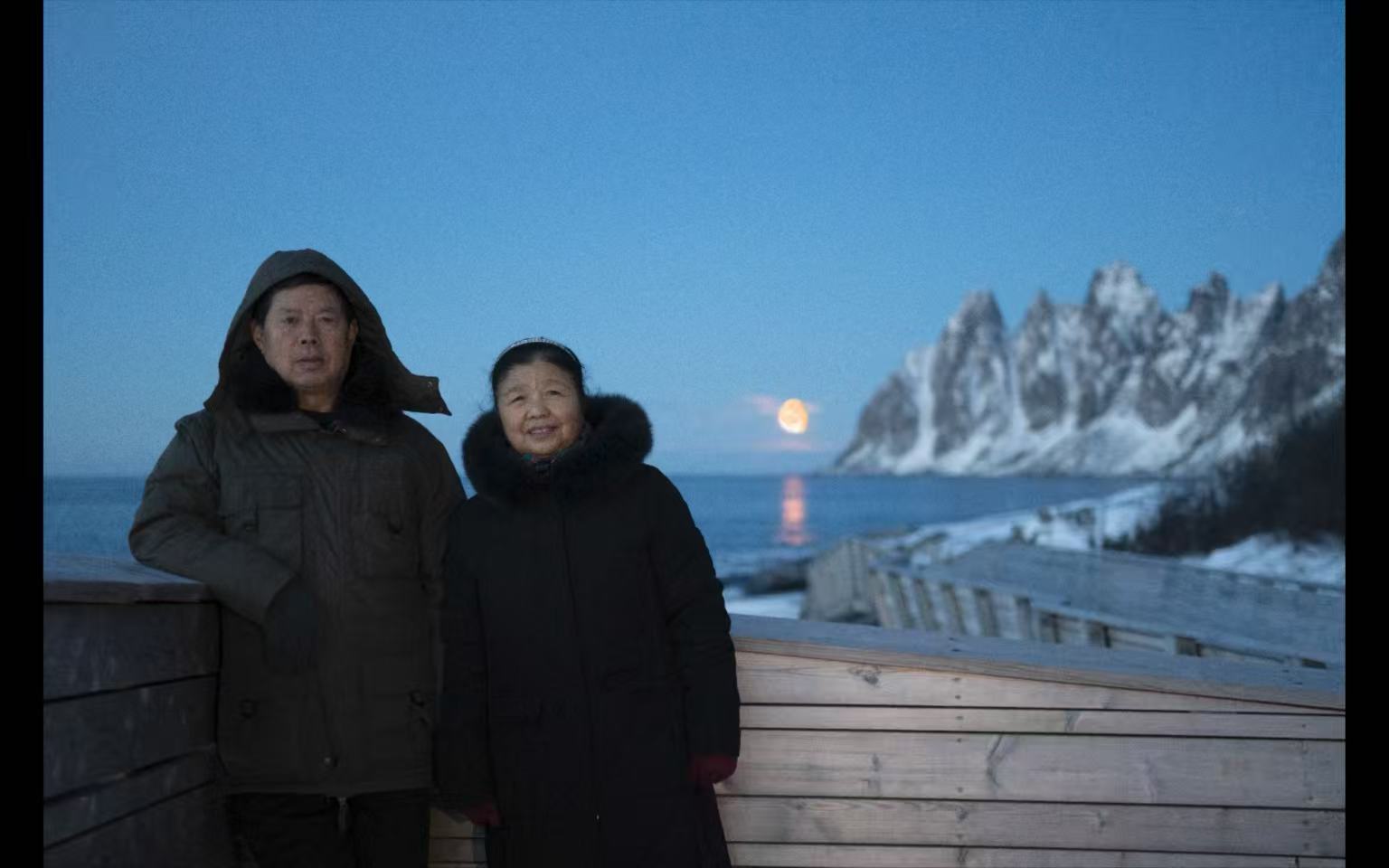 Guests standing beneath the northern lights