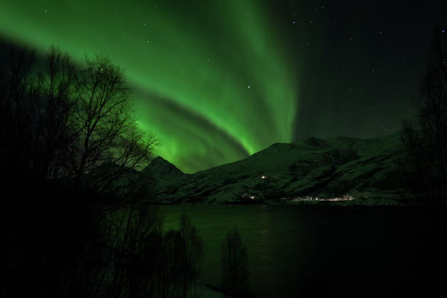 Aurora over distant Arctic peaks
